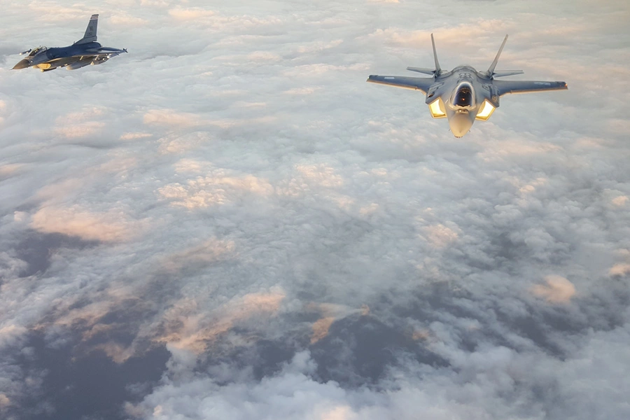 A U.S. Air Force F-16 (left) escorts a Japan Air Self-Defense Force F-35A (right) over the Pacific Ocean on November 6, 2017.