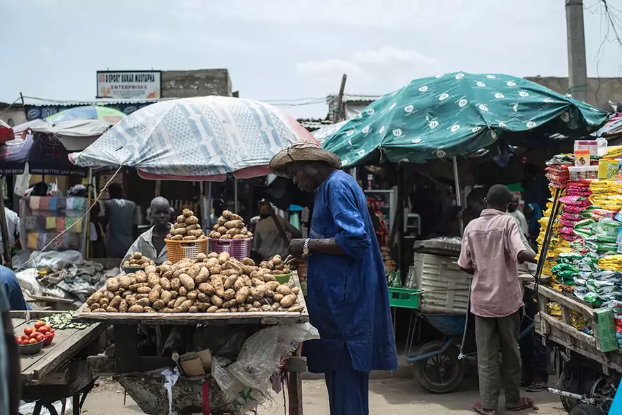 A man looks at potatoes displayed on a stall at the Monday-Market, one of the biggest markets, in Maiduguri in northeastern Nigeria, on July 4, 2017. Due to the Boko Haram insurgency in Maiduguri, there has seen a sharp increase in food prices.