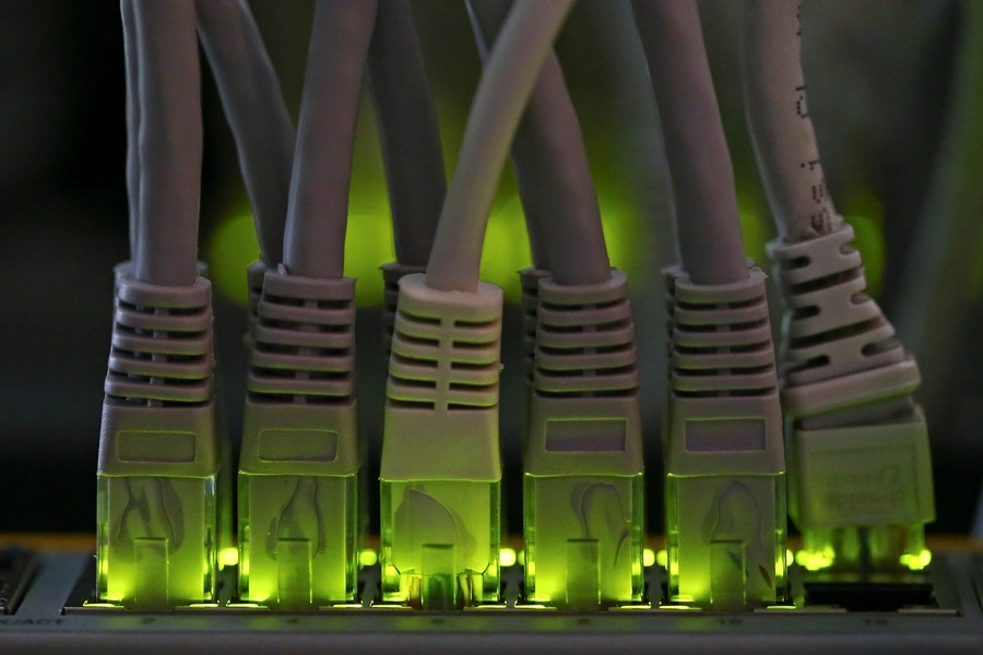 LAN network cables plugged into a Bitcoin mining computer server are pictured in Bitminer Factory in Florence, Italy, April 6, 2018