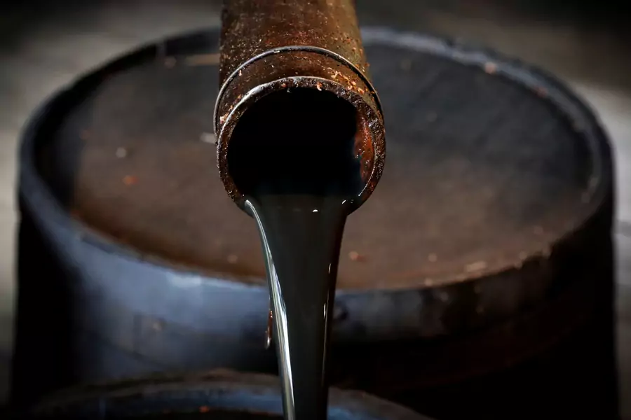 Oil pours out of a spout.
