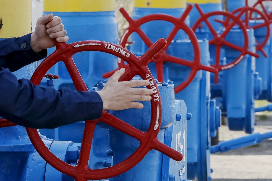 An employee turns a valve at a gas compressor station in the village of Boyarka, outside Kiev, April 22, 2015