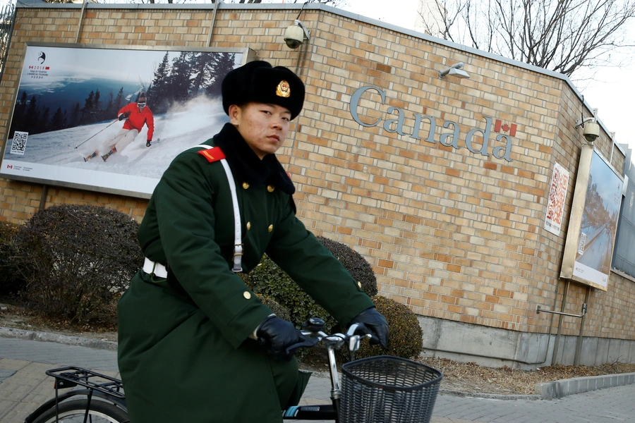 A paramilitary police officer cycles past the embassy of Canada in Beijing, China on December 12, 2018.