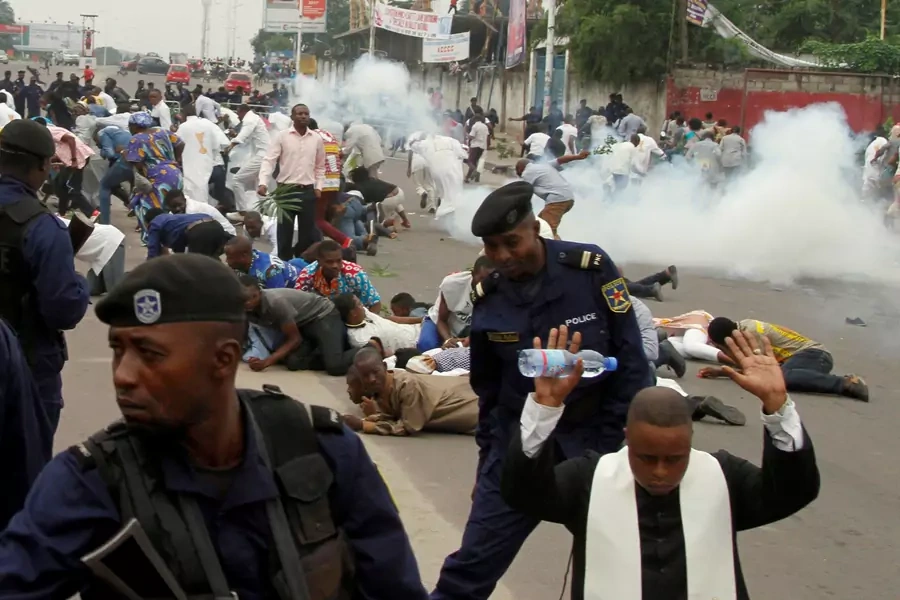 Riot policemen fire tear gas to disperse Catholic priests and demonstrators during a protest against President Joseph Kabila organized by the Catholic church in Kinshasa, Democratic Republic of Congo, on January 21, 2018.