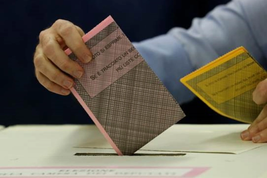 A man casts his vote at a polling station in Milan during Italy’s March 2018 election. 