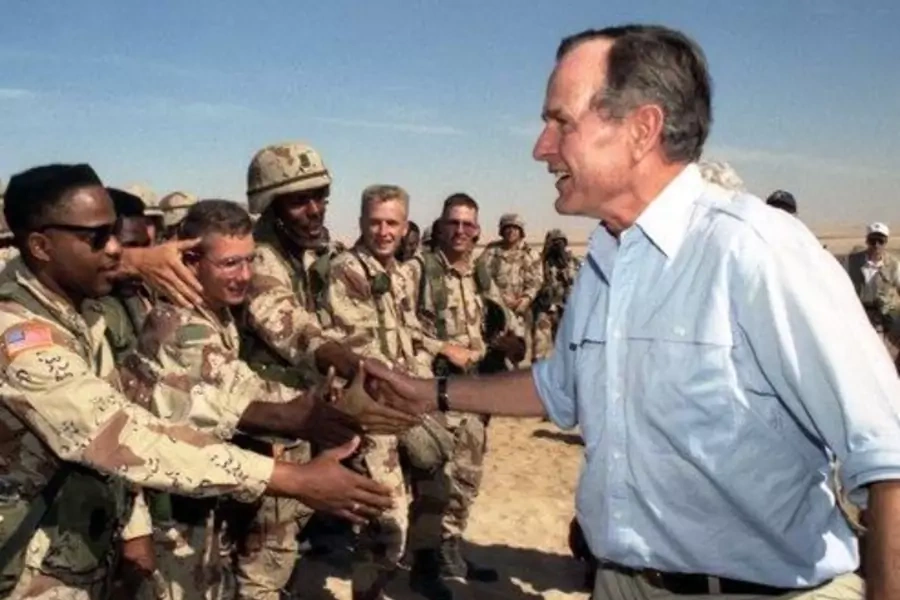 President George H.W. Bush greets troops in Saudi Arabia during a 1990 Thanksgiving visit. 