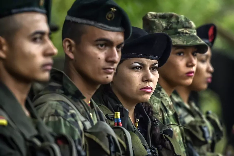 Members of the Revolutionary Armed Forces of Colombia stand during a ceremony at a camp in the Colombian mountains.
