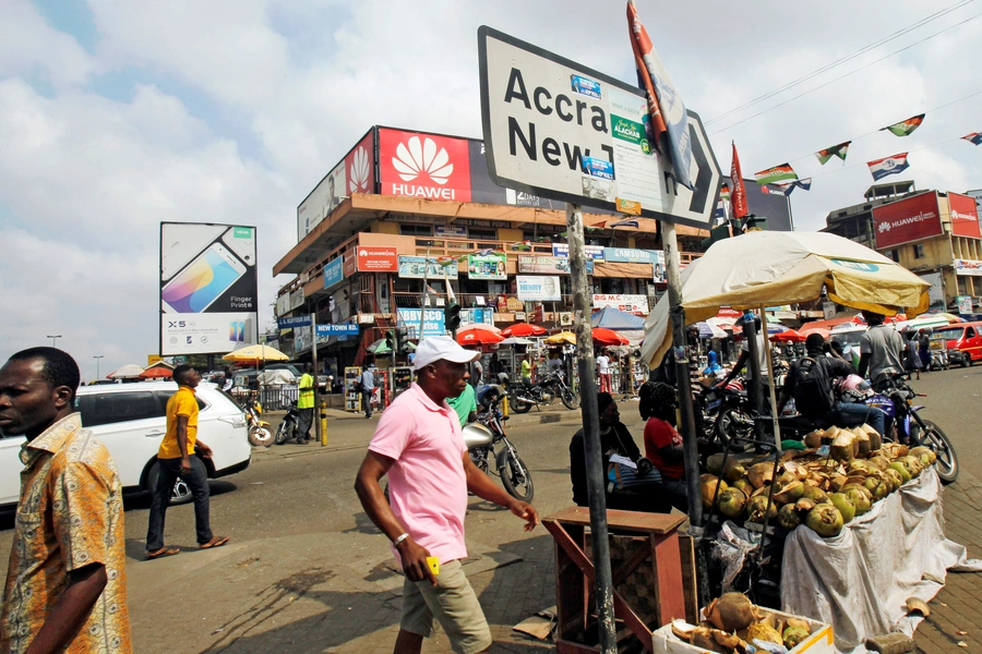 People walk on the street around Kwame Nkrumah circle in Accra, Ghana, on December 2, 2016.