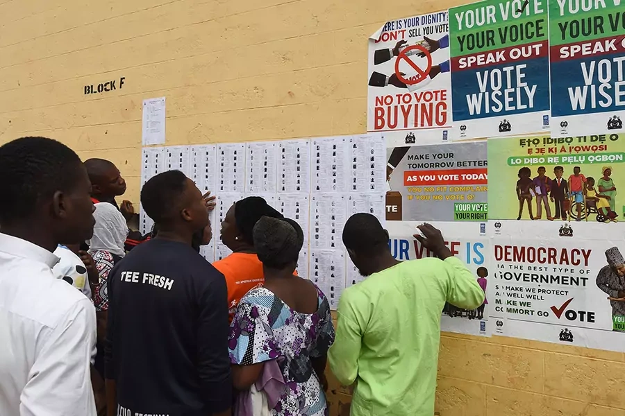 Voters searching for their details placarded on the wall during the Osun State gubernatorial election, near Osogbo, Osun State in southwest Nigeria, on September 22, 2018.