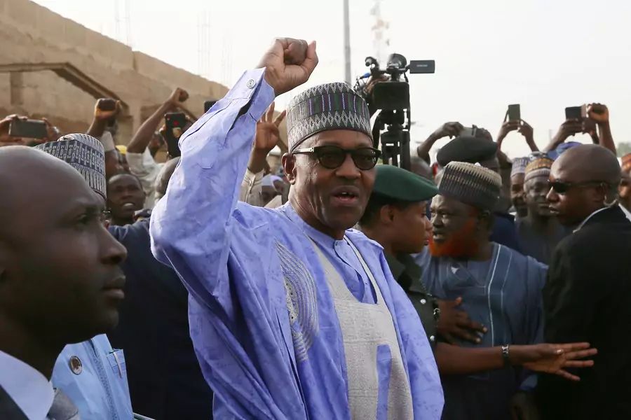 Nigerian President Muhammadu Buhari gestures as he arrives to cast a vote in Nigeria's presidential election at a polling station in Daura, Katsina State, Nigeria, February 23, 2019. 