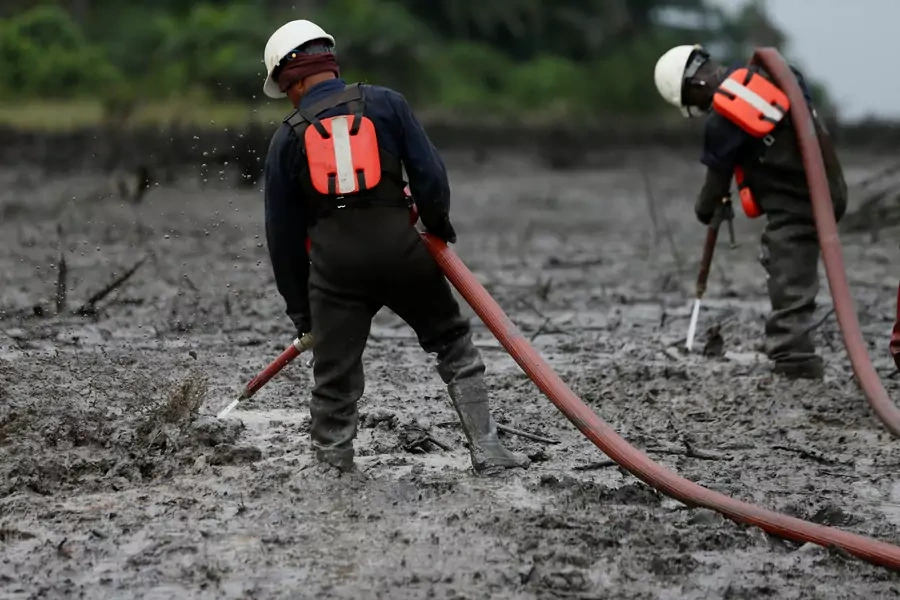 Workers flush the crude oil polluted creek shoreline at the Bodo clean-up site in Rivers State, Nigeria, on November 1, 2017.