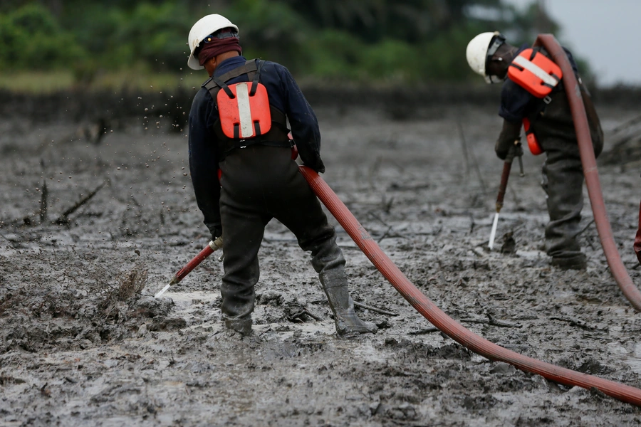 Workers flush the crude oil polluted creek shoreline at the Bodo clean-up site in Rivers State, Nigeria, on November 1, 2017.