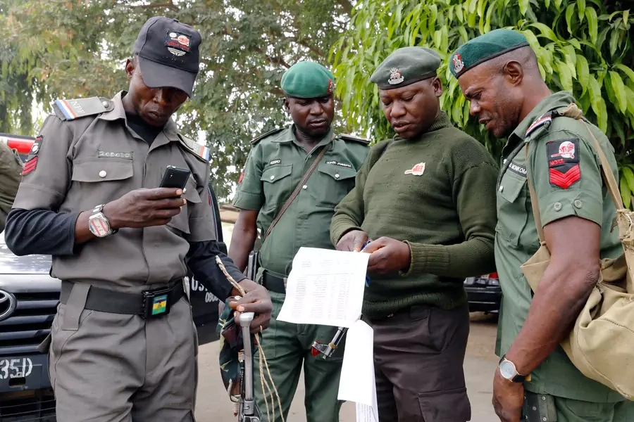 Police officers at the INEC office discuss as they prepare for deployment in Adamawa State, ahead of the country's presidential election, in Yola, Nigeria, on February 15, 2019. 