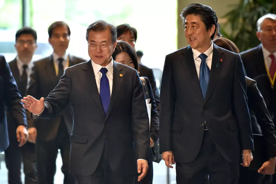 South Korea's President Moon Jae-in is greeted by Japan's Prime Minister Shinzo Abe prior to their meeting at Abe's official residence in Tokyo, Japan on May 9, 2018. 