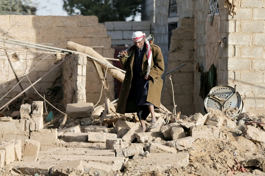 A man walks at the site of a Saudi-led air strike in the Houthi-held capital Sana'a, Yemen, on January 20, 2019.