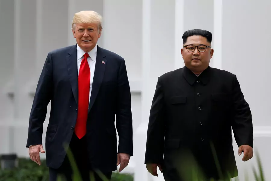 U.S. President Donald Trump and North Korean leader Kim Jong-un walk after lunch at the Capella Hotel on Sentosa island in Singapore on June 12, 2018.