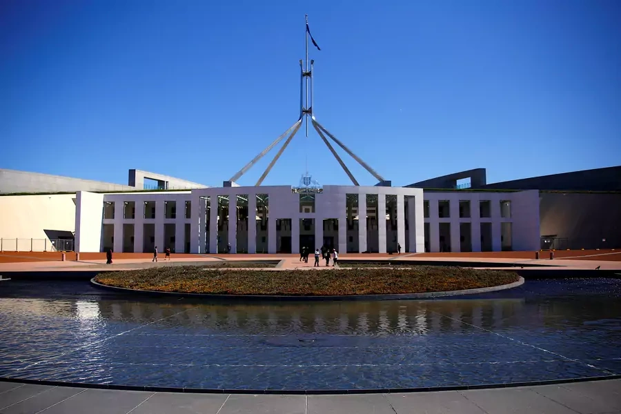 Tourists walk around the forecourt of Australia's Parliament House in Canberr