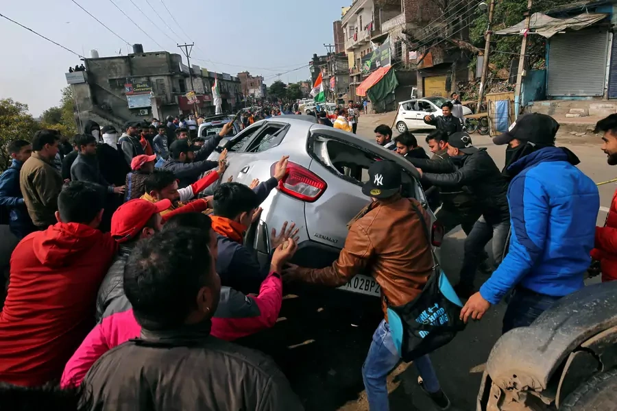 Demonstrators overturn a car during a protest against the attack on a bus that killed forty-four Central Reserve Police Force personnel in Indian-administered Kashmir on Thursday, February 14, 2019. 