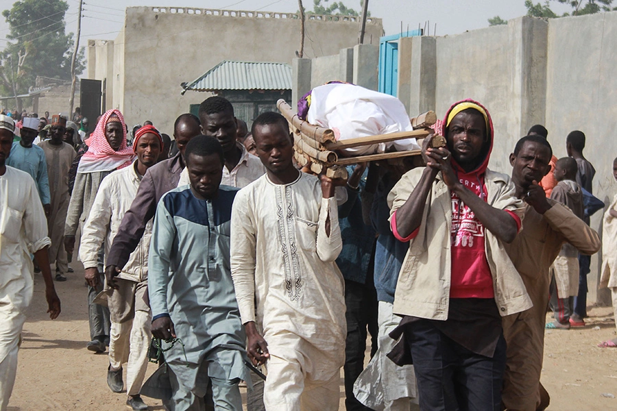 People carry the body of one of Boko Haram attack victims during their burial ceremony at the Sajeri village on the outskirts of the Borno state capital, Maiduguri, on January 8, 2019.