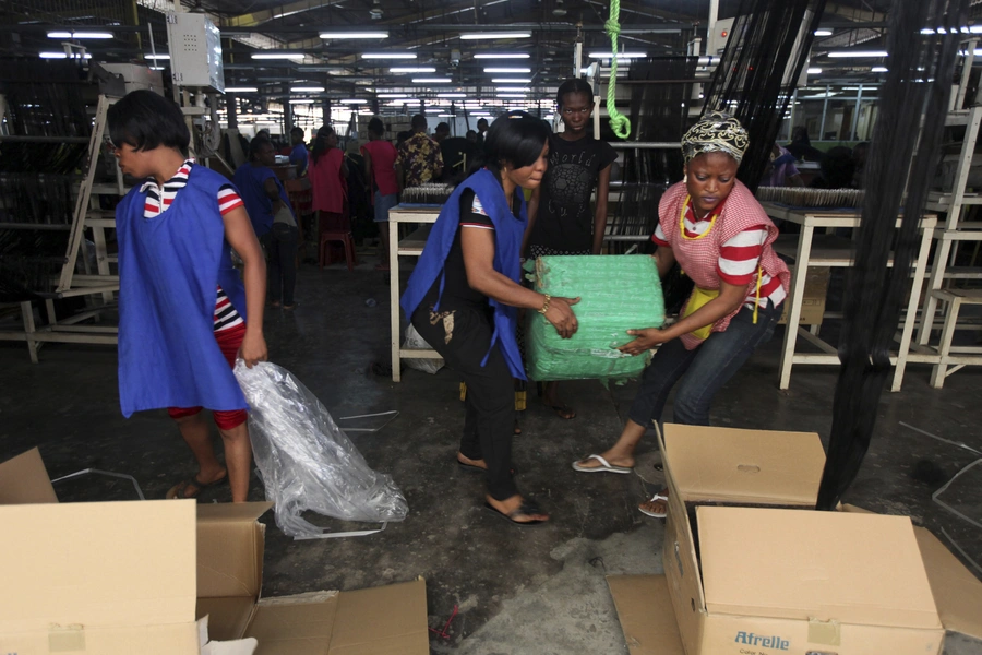 Women work in Amingos fiber hair factory in Ikeja district in Lagos, on December 1, 2011.