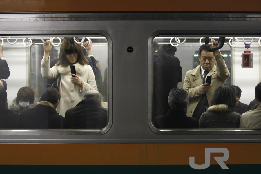 Commuters go home by train at Tokyo station March 23, 2011.