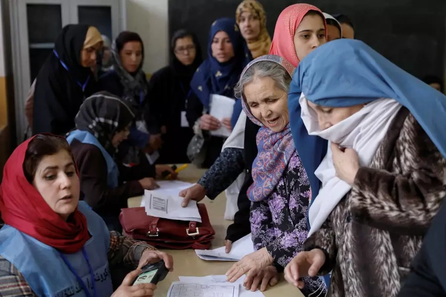 Afghan women line up at a polling station during parliamentary elections in Kabul, Afghanistan October 20, 2018.