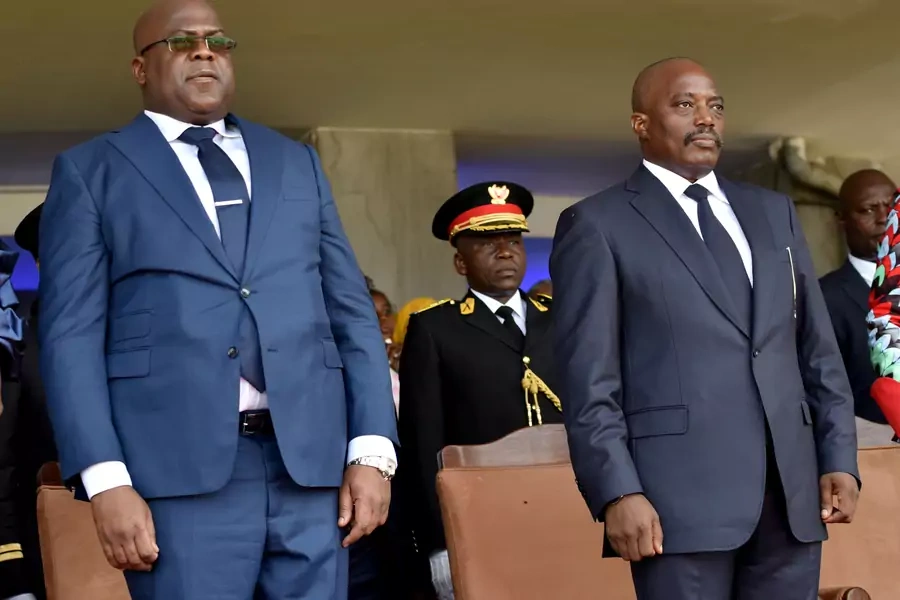 Democratic Republic of Congo's outgoing President Joseph Kabila (right) and his successor Felix Tshisekedi stand during Tshisekedi's inauguration ceremony  in Kinshasa, Democratic Republic of Congo, on January 24, 2019.