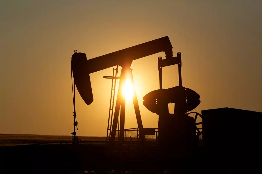 An oil pump jack pumps oil in a field near Calgary, Alberta, Canada on July 21, 2014