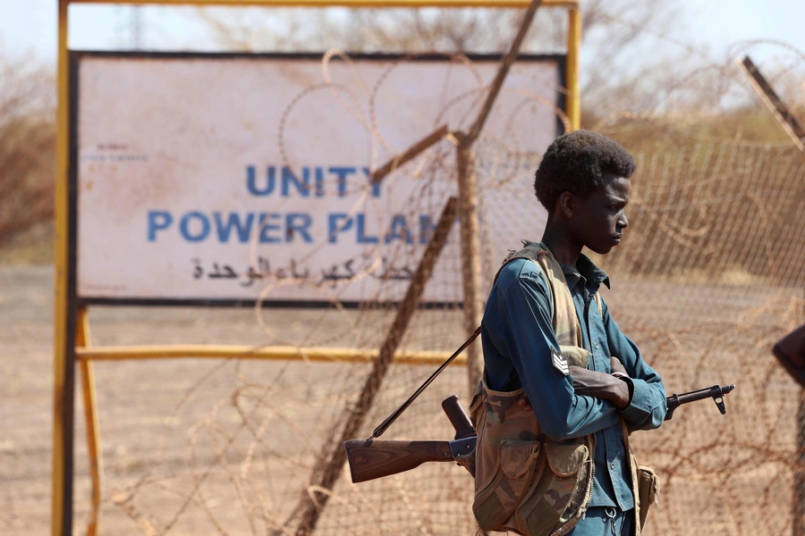 An armed South Sudanese policeman is seen during a ceremony marking the restarting of crude oil pumping at the Unity oil fields in South Sudan, on January 21, 2019.