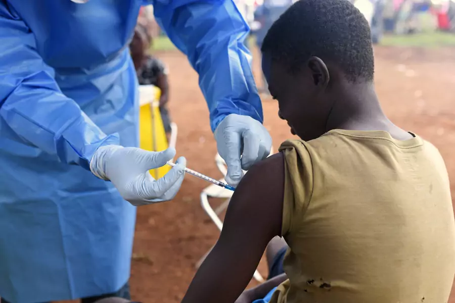 A Congolese health worker administers Ebola vaccine to a boy who had contact with an Ebola sufferer in the village of Mangina in North Kivu province of the Democratic Republic of Congo, on August 18, 2018. 