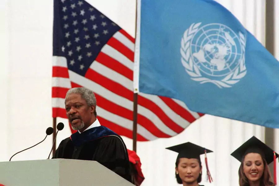 UN Secretary General Kofi Annan of Ghana is flanked by U.S. and UN flags as he delivers the Masachusetts Institute of Technology's 1997 commencement address on June 6. 