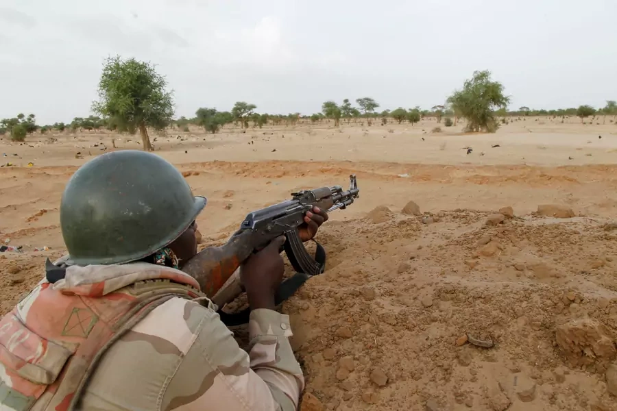 A Nigerien soldier guards with his weapon pointed towards the border with neighboring Nigeria, near the town of Diffa, Niger, on June 21, 2016.