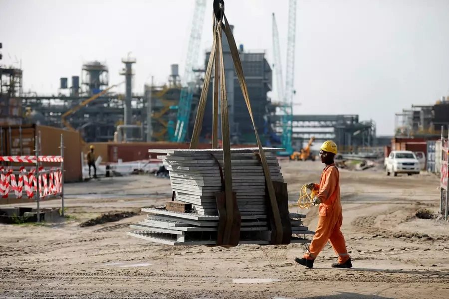 A construction worker assists with moving building materials on a lift at the Dangote Oil Refinery under construction, in Ibeju Lekki district, on the outskirts of Lagos, Nigeria, on July 5, 2018. 