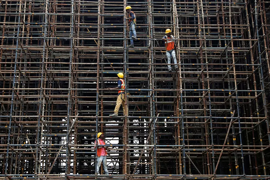 Laborers work at the construction site of a metro rail station in Kolkata, India, July 2, 2018.
