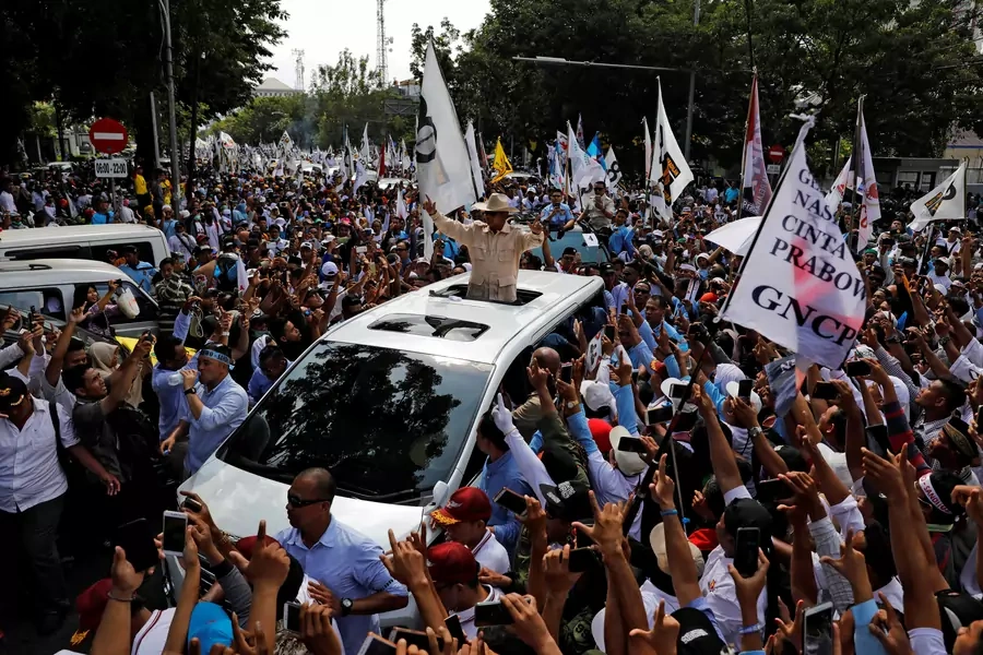 Indonesia's presidential candidate Prabowo Subianto, who was a former general of the Indonesian military, gestures as he greets supporters from a car during a campaign rally in Solo, Central Java Province, Indonesia, on April 10, 2019.