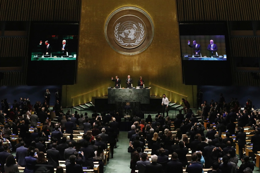 United Nations Secretary-General Ban Ki-moon waves to the assembly after speaking during the swearing-in of Secretary-General-designate Mr. Antonio Guterres at UN headquarters in New York, U.S., December 12, 2016.