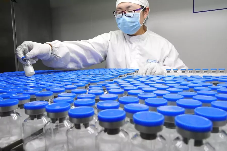 A technician inspects anti-cancer drugs in vials at a lab of a pharmaceutical company in Lianyungang, Jiangsu province, China March 13, 2019. REUTERS/Stringer 