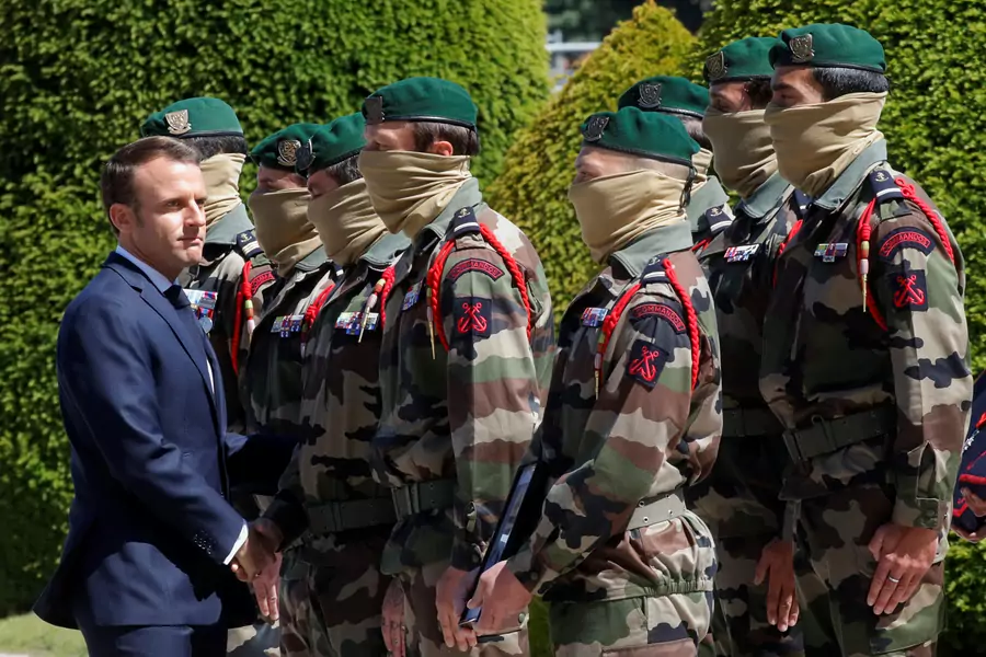 French President Emmanuel Macron shakes hands with the special forces soldiers during a national tribute for two soldiers who were killed in a night-time rescue in Burkina Faso of four foreign hostages in Paris, France, on May 14, 2019. 