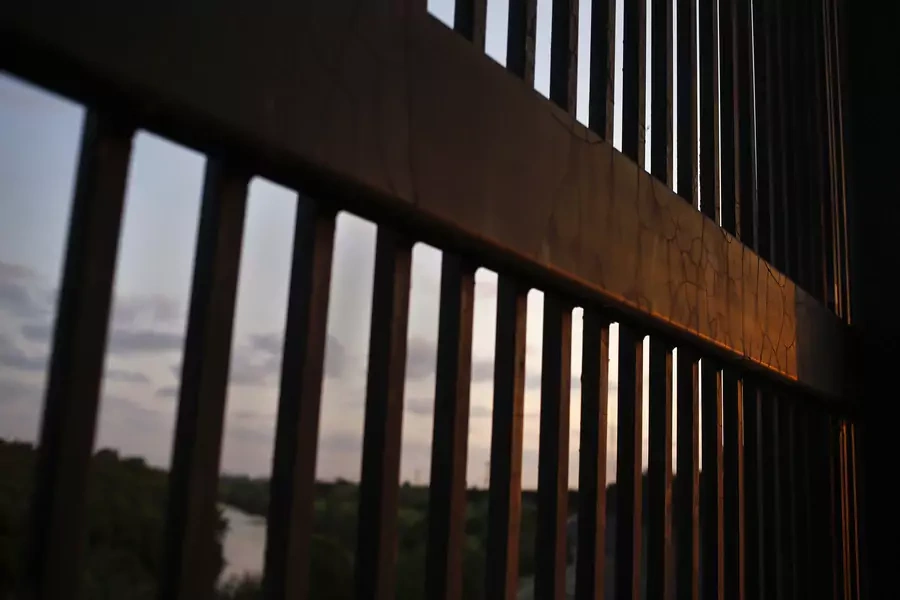 The border fence stands at the United States-Mexico border along the Rio Grande river in Brownsville, Texas, August 5, 2014.