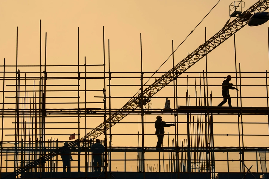 Workers are seen on scaffolding at a construction site in Nantong, Jiangsu province, China, on January 1, 2019.