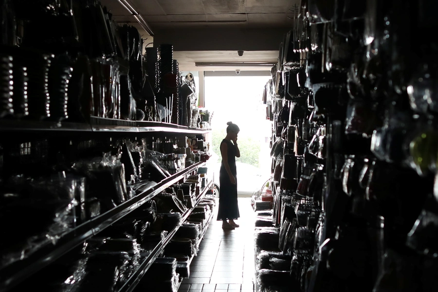 A shopper looks for goods during an electricity load-shedding blackout in Johannesburg, South Africa, February 12, 2019.