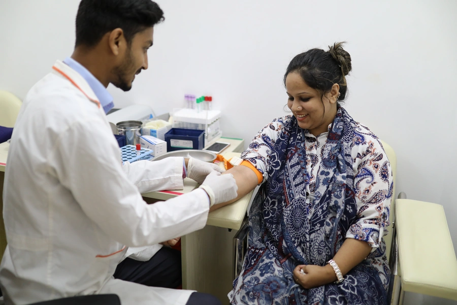 A woman sees a doctor at a Praava Health facility in Bangladesh.