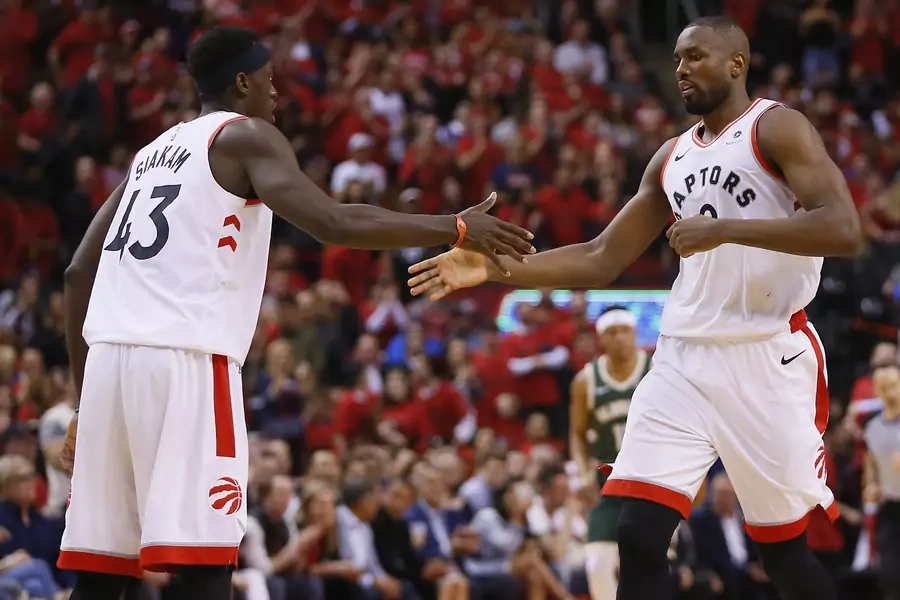 Toronto Raptors' Pascal Siakam (Cameroon) and Serge Ibaka (Republic of Congo) celebrate a play against the Milwaukee Bucks during game four of the Eastern conference finals of the 2019 NBA Playoffs at Scotiabank Arena in Toronto, Canada, on May 21, 2019.