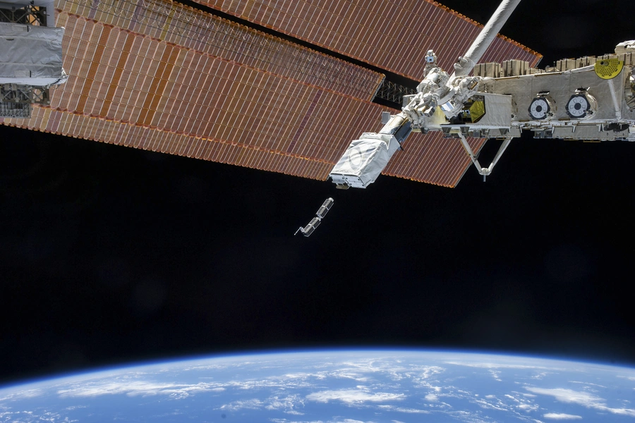 The Small Satellite Orbital Deployer, in the grasp of the Kibo laboratory robotic arm, deploys a set of NanoRacks CubeSats.