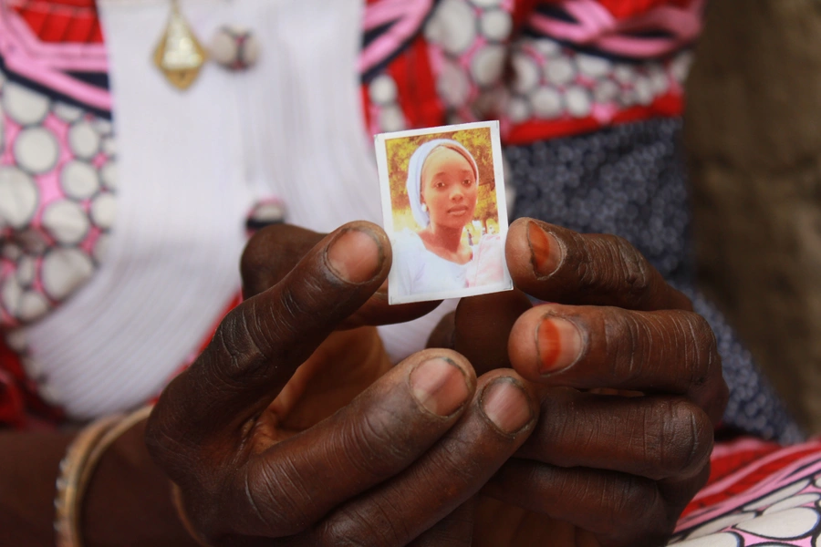 Zainabu Mala, mother of Kabu, one of the abducted girls, holds a picture of her daughter on April 12, 2019, in Chibok.