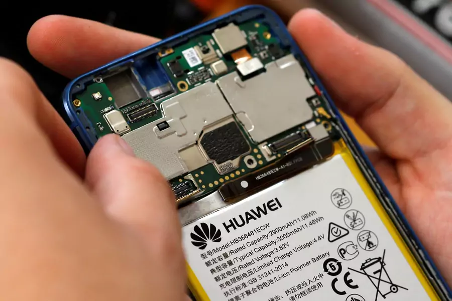A worker refurbishes a Huawei cell phone at a workshop. June 20, 2019.