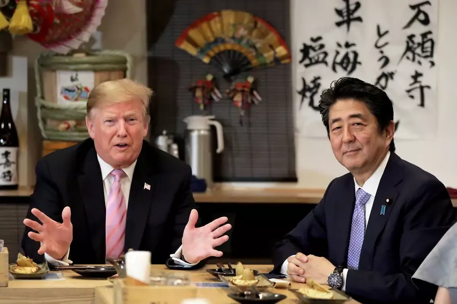 U.S. President Donald Trump talks with Japanese Prime Minister Shinzo Abe during a couples dinner with first lady Melania Trump and Abe's wife Akie in Tokyo, Japan, on May 26, 2019.
