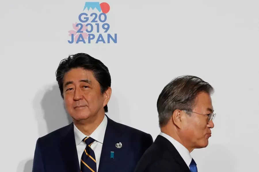 South Korean President Moon Jae-in is welcomed by Japanese Prime Minister Shinzo Abe upon his arrival for a welcome photo session at the G20 leaders summit in Osaka, Japan, on June 28, 2019.
