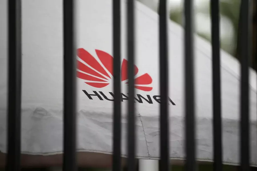 A Huawei logo is seen outside the fence at its headquarters in Shenzhen.