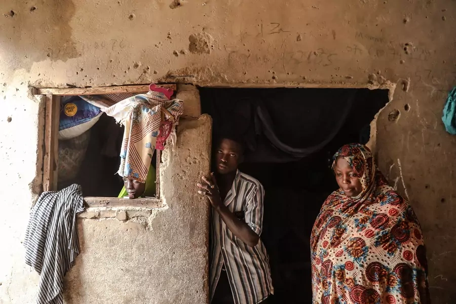 Hadiza, an internally displaced person from Baga local government area in Borno State in Nigeria, poses with family members on July 21, 2019, in Markas, the mosque of Boko Haram leader Mohammed Yusuf in Old Maiduguri where she currently resides.