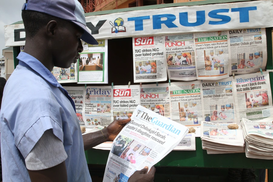 A man looks at a newspaper headline in Abuja, Nigeria, on May 20, 2016.